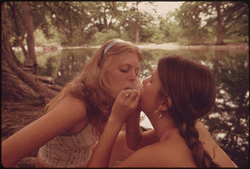 80. Two Girls Smoking Pot During an Outing in Cedar Woods near Leakey, Texas. Near San Antonio 05/1973. Photographer: Marc St. Gil