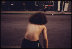 36. Boys Playing Frisbee Across West 46th Street in Manhattan New York City, 07/1974. Photographer: Danny Lyon