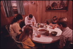 16. The Wayne Gipson Family Says a Prayer before Their Evening Meal in the Kitchen of Their Modern Home near Gruetli, near Chattanooga, Tennessee 12/1974. Photographer: Jack Corn