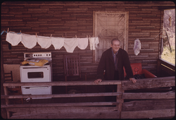 54. Hiram Lilly, 84, Stands on the Porch of His Daughter's Home in Fireco, near Beckley, West Virginia. The Retired Miner Lives with Her Fireco Was Once a Great Mining Town, But the Region Has Been Mined Out 05/1974. Photographer: Jack Corn